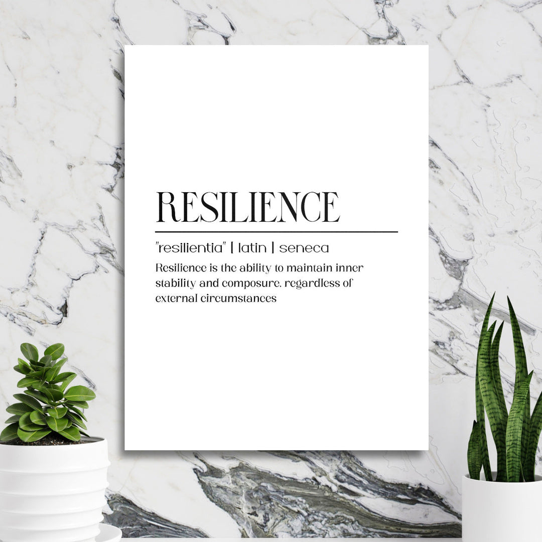 Motivational wall art with a RESILIENCE quote in a minimalist design on a marble wall with plants