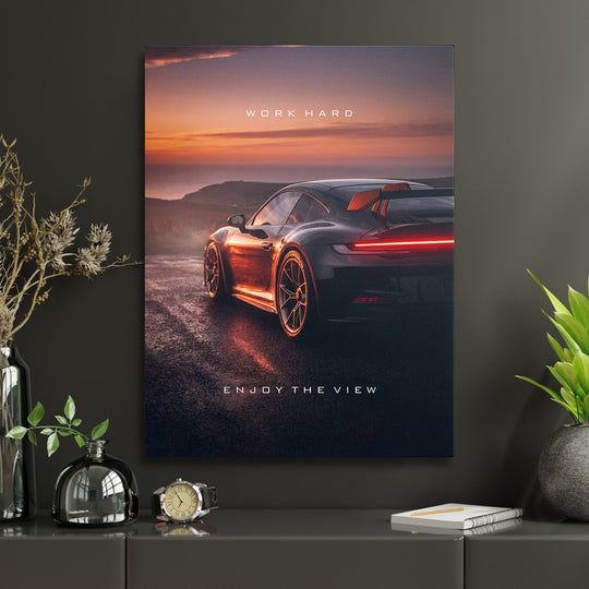 Motivational wall art with luxury sports car on a road at sunset, modern lifestyle scene