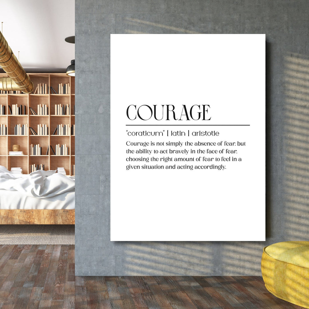 Motivational wall art with a minimalist quote about courage on a concrete wall next to a bookcase