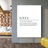 FOCUS motivational wall art with minimalist typography on a concrete wall in a modern living room beside a bookcase