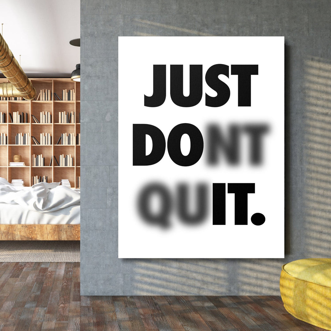 Motivational canvas wall art in a living room with a minimalist black and white quote and slightly blurred lower line