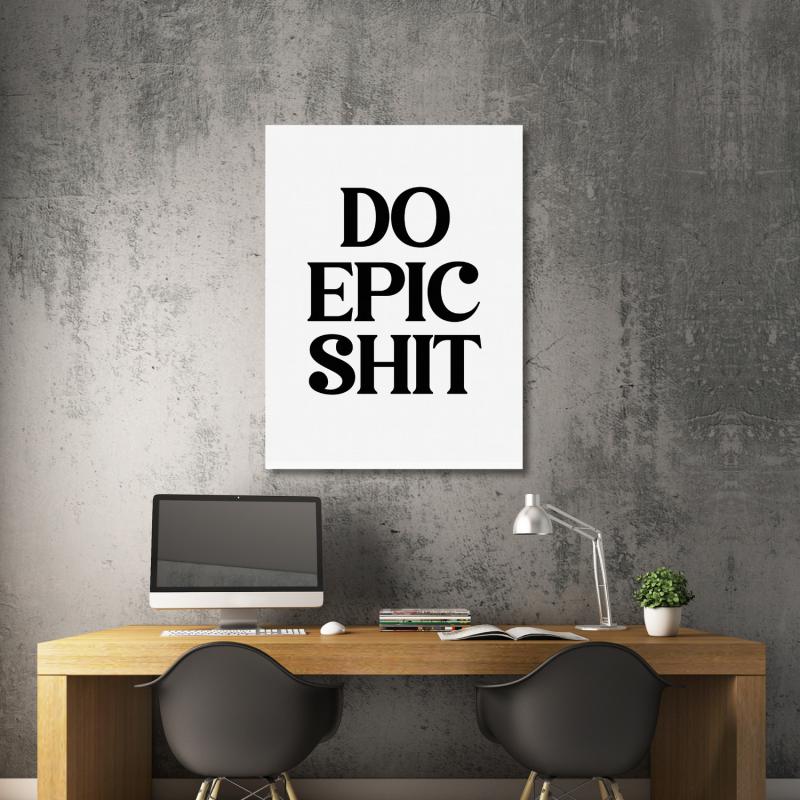 Motivational wall art with black “DO EPIC SHIT” text in a modern office above a wooden desk.