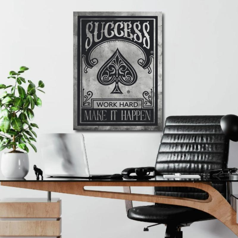 Office motivational wall art with black and white minimalist spade graphic and quote in a lifestyle interior.
