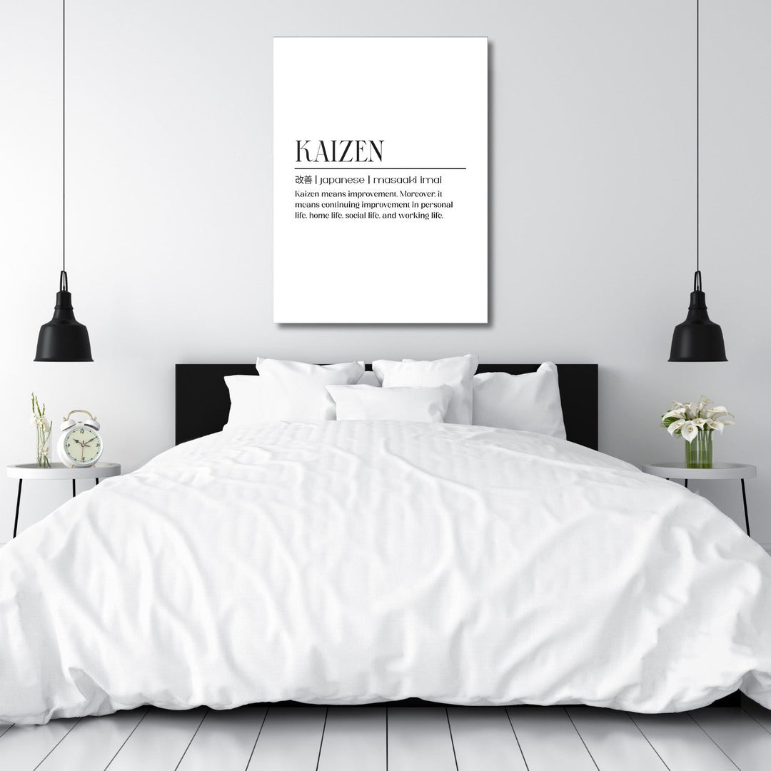 Kaizen motivational canvas print with a quote above the bed in a modern minimalist bedroom