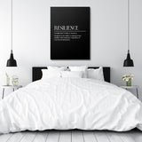 Motivational canvas print with a Resilience quote hanging above a white bed in a minimalist bedroom