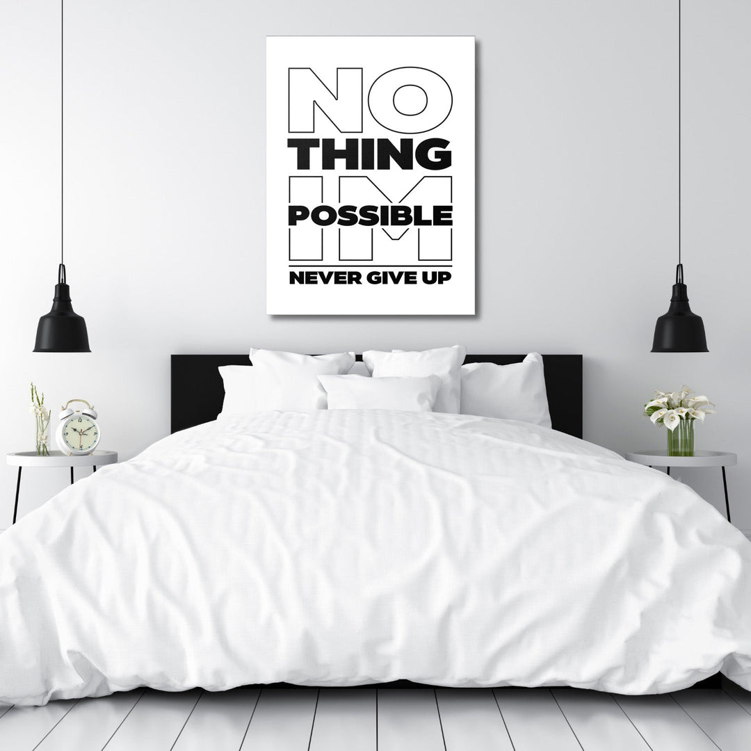 Black and white “NO THING IM POSSIBLE NEVER GIVE UP” motivational canvas wall art hanging above a bedroom bed