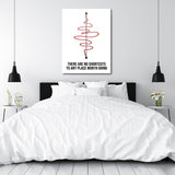 Motivational canvas print for a bedroom with a black-and-white quote and red spiral in a minimalist design