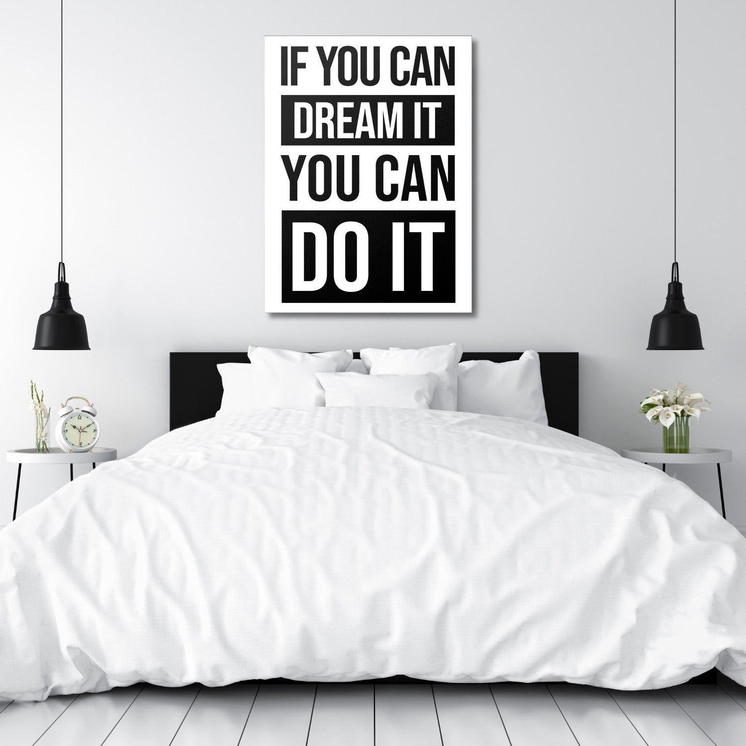 Black and white motivational quote canvas wall art above a bed in a minimalist modern bedroom