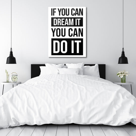 Black and white motivational quote canvas wall art above a bed in a minimalist modern bedroom