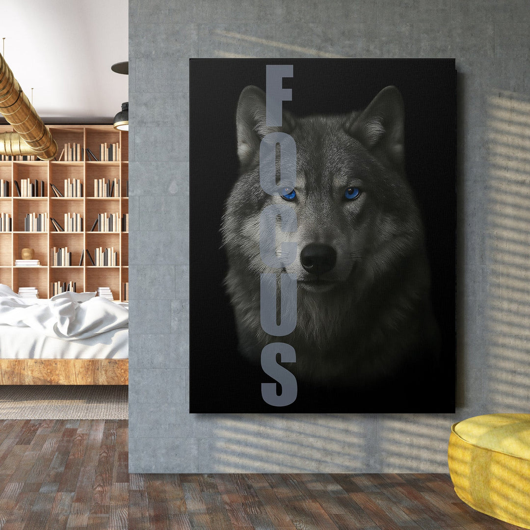 Motivational canvas wall art with a wolf and FOCUS text on a concrete wall in a modern office.