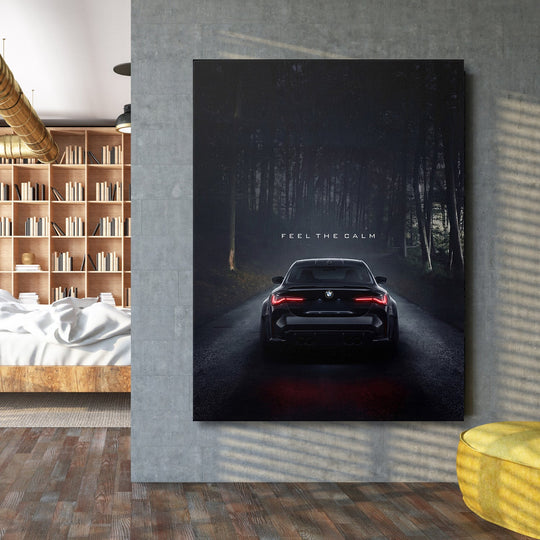 Motivational wall art with a BMW on a dark forest road and the text “Feel the Calm” in a living room