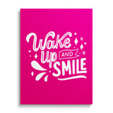Motivational canvas print with the phrase “Wake up and smile” on a pink background in a minimalist style