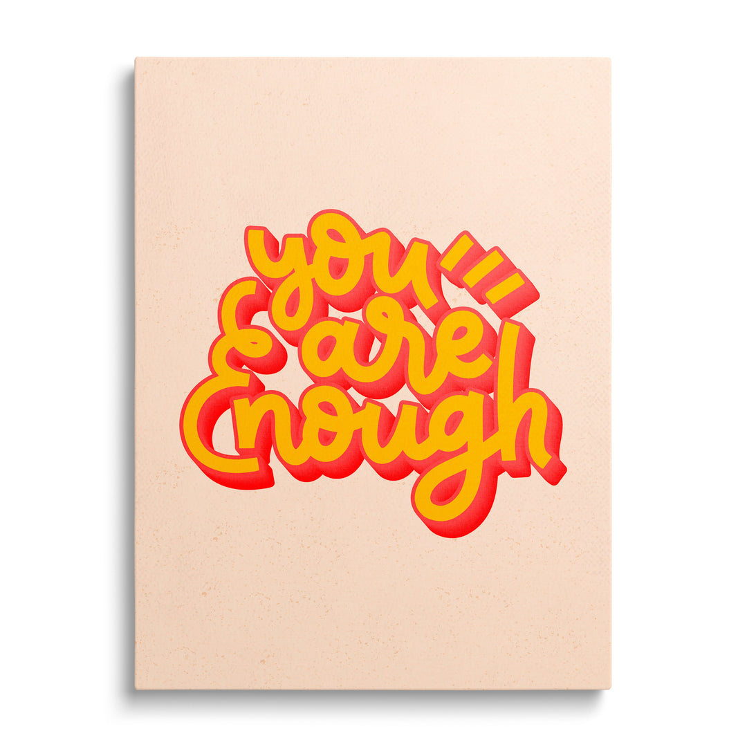 Pop art canvas print with the motivational phrase “You Are Enough” in yellow with a red shadow, front view