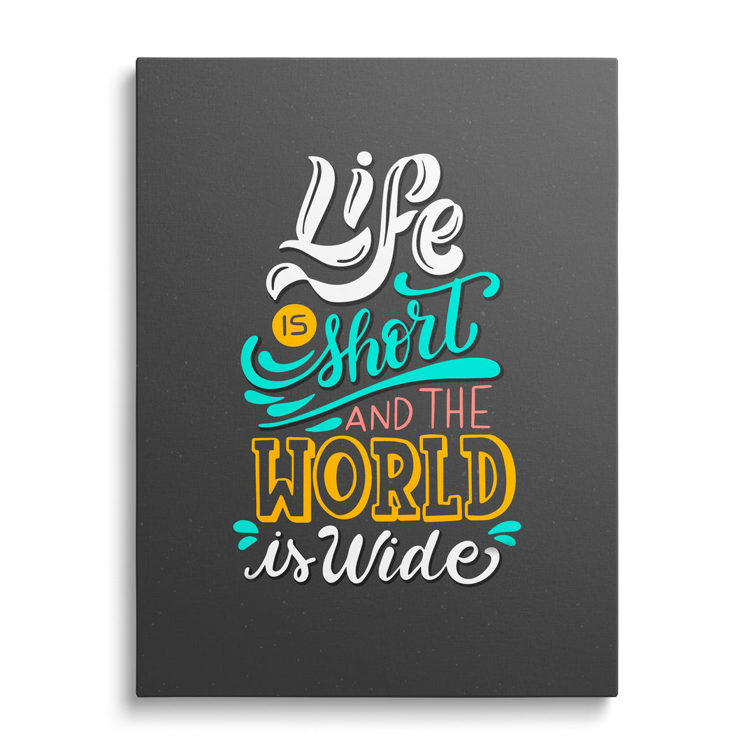 Motivational canvas print with the colorful travel quote “Life is short and the world is wide” on a dark background