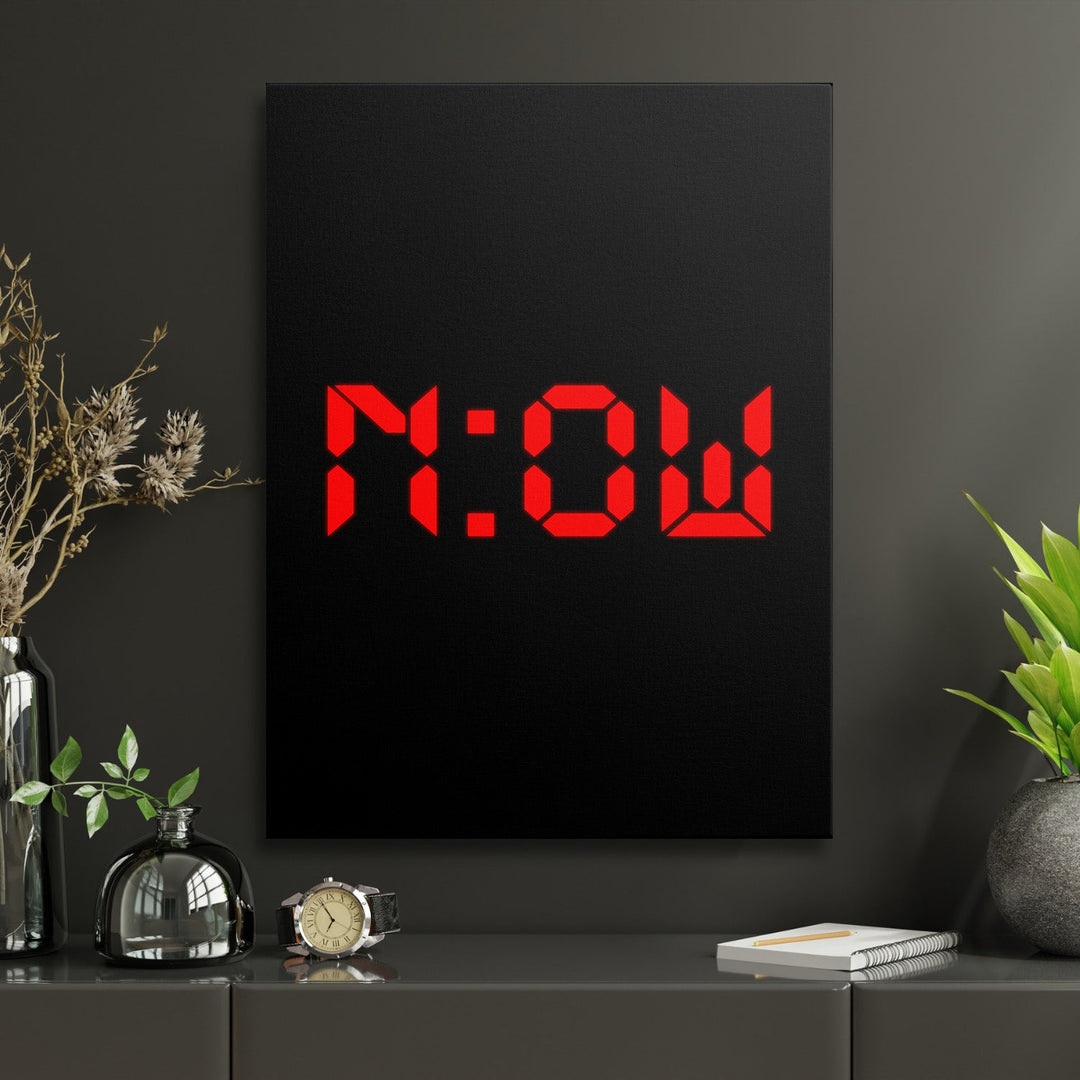 Motivational canvas print with red NOW lettering in a minimalist home office