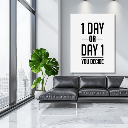 Motivational wall art with black-and-white “1 DAY OR DAY 1” typography in a modern living room with a leather sofa.