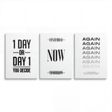Motivational canvas wall art set with three black-and-white minimalist prints reading “1 Day or Day 1”, “Now” and “Again”