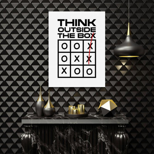 Motivational wall art in a modern office with a minimalist “Think Outside the Box” quote and tic-tac-toe motif.