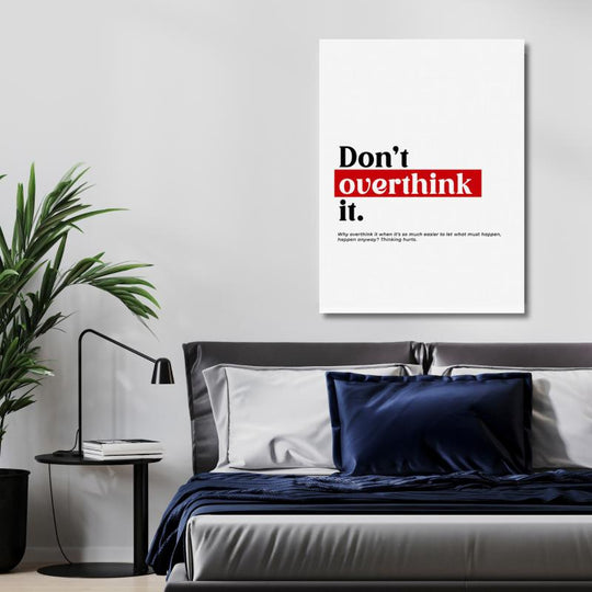 “Don’t Overthink It” motivational canvas wall art above a bed in a modern minimalist bedroom.